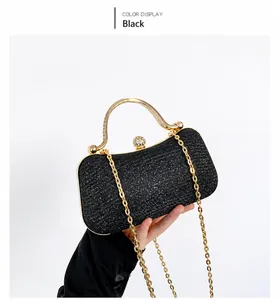 Macro shot of black glitter evening bag with pearl clasp and gold metal handle