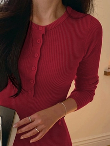 Elegant red ribbed knit midi dress with long sleeves and buttoned neckline detail