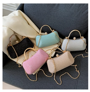 Detailed macro view of glitter evening clutch bags in various colors with gold chain straps
