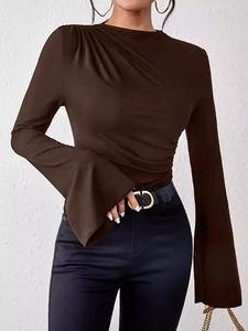 Detailed view of the elegant flared cuffs and ruched shoulder design on the brown top