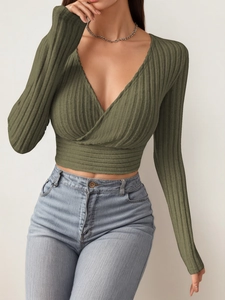 Detailed texture of olive green ribbed knit fabric and deep V-neck wrap design