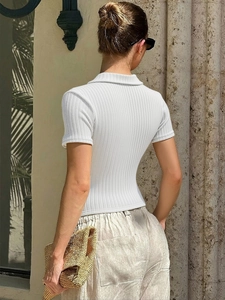 Chic white ribbed knit polo shirt for women featuring a slim fit and cropped short sleeves