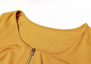 Detail of ginger yellow ribbed knit bodysuit featuring a low-cut scoop neck and zipper