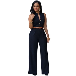 Detail of high waist sleeveless jumpsuit featuring gold buttons and a brown leather belt