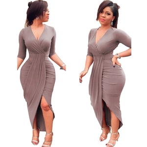 Detail of V-neck wrap dress featuring waist ruching and asymmetrical tulip hemline