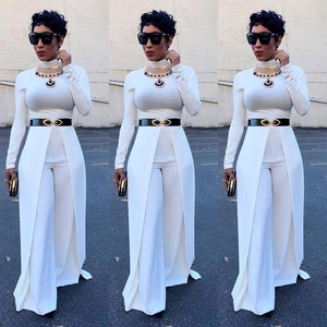 Detail of white wide-leg jumpsuit set with high slit skirt overlay and gold eyelet belt