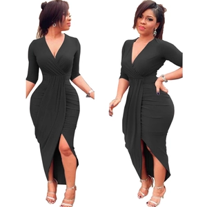 Detail of black V-neck wrap dress featuring waist ruching and asymmetrical hemline
