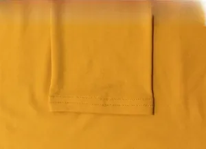 Close-up of double-needle stitching on the sleeve of a ginger yellow bodysuit
