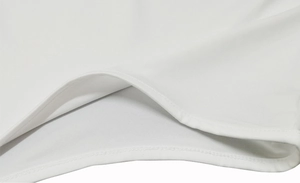 Close-up of high-quality white knitted fabric showing precise stitching on the bodysuit neck