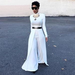 Detail of white long sleeve jumpsuit with waist belt and ornate gold eye buckle