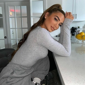 Detail of heather grey ribbed thermal bodysuit showing zipper collar and long sleeve fit
