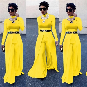 Detail of yellow long sleeve wide leg jumpsuit featuring waist belt and front slit design