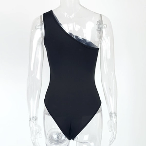 Detail view of black one-shoulder bodysuit showing smooth matte fabric and high-cut leg line