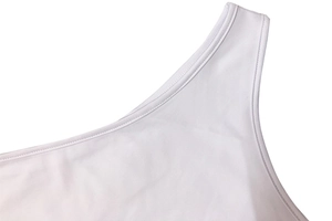 Close-up of white bodysuit featuring double-stitched seams and smooth elastic fabric detail