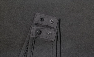 Detail view of the black bodysuit crotch with durable double-row snap button closure