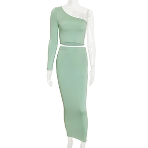 Detail of mint green two-piece set featuring one-shoulder crop top and high waist maxi skirt
