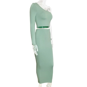 Detail view of sage green two-piece set featuring one-shoulder crop top and maxi skirt