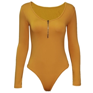 Close-up of mustard yellow long sleeve bodysuit featuring u-neck and front zipper detail