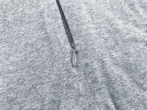 Detail view of grey knit bodysuit featuring a high-quality invisible zipper closure