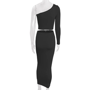 Detail of black two-piece set featuring off-shoulder crop top and high waist maxi skirt
