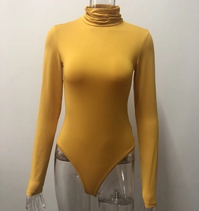 Detail of ginger yellow high neck bodysuit showing elastic knit fabric and slim fit design