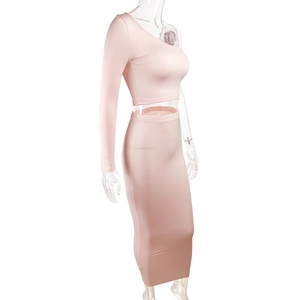 Detail of light pink one-shoulder top and high-waist maxi skirt in elastic knit fabric