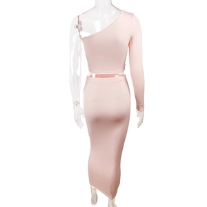 Detail view of pink two-piece set featuring off-shoulder top and high-waist skirt from behind
