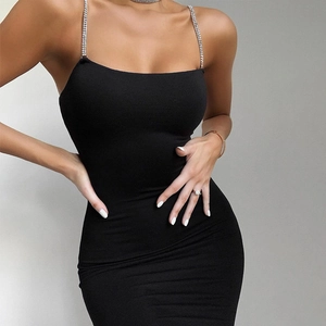 Détail d'une robe moulante noire avec des bretelles luxueuses en chaîne de strass brillants