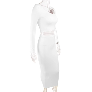 Close-up of white two-piece bodycon set featuring a long sleeve crop top and maxi skirt