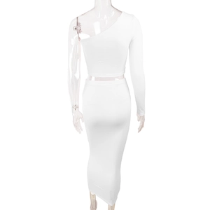 Rear view of white two-piece set featuring one-shoulder crop top and slim maxi skirt