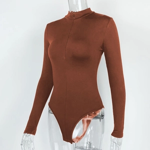 Close-up of caramel ribbed bodysuit featuring standing collar and front zipper detail