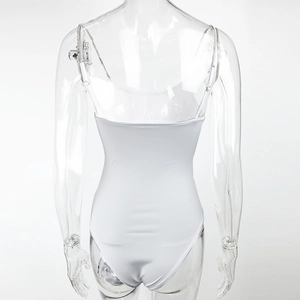 Back view of white slim bodysuit featuring open back and silver diamond chain straps
