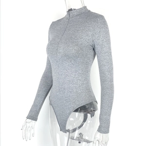 Detail of grey long sleeve bodysuit featuring stand collar and zipper on knit fabric