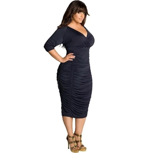 Detail of plus size black V-neck dress featuring ruched sides and slimming fitted waist
