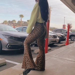 Outdoor street style shot of high-waisted leopard print flare pants with slim fit