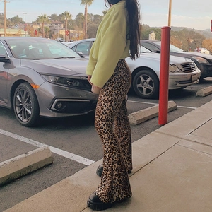 Detail of high waisted leopard print flare pants paired with a cropped fleece jacket