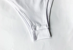 Detail of high-quality double-needle stitching on the white bodysuit crotch area