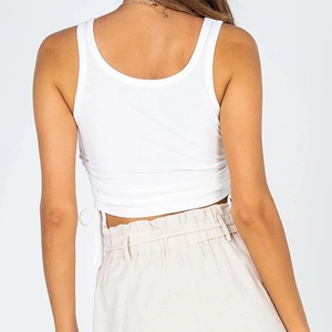 Detail view of white ribbed crop top featuring adjustable side drawstring and ruching