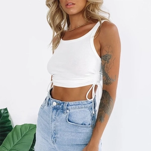 Close-up of white ribbed crop top featuring adjustable side drawstrings and ruching details
