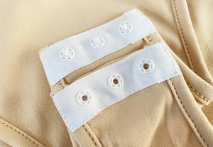 Detail of adjustable double-row triple hooks on seamless nude bodysuit fabric
