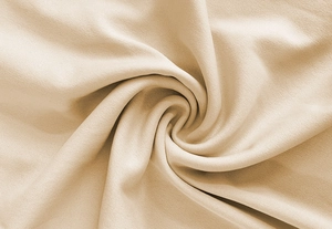 Detail view of soft beige ribbed fabric texture and draping material for a sleek bodysuit