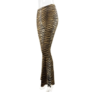 Close-up of tiger print flared trousers with high-waist fit and elastic slim fabric