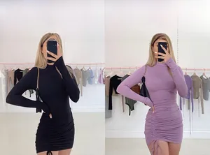 Detail view of ruched bodycon mini dress featuring side drawstrings in black and purple