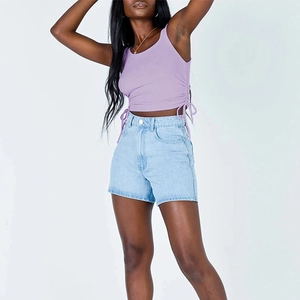 Close-up of lavender ribbed tank top with adjustable side drawstrings and denim shorts