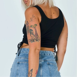 Detailed view of black ribbed crop top featuring adjustable side drawstrings and ruched texture