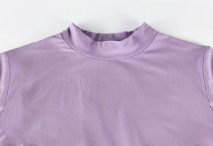 Close-up of the mock neck collar and stitching detail on the purple slim-fit dress