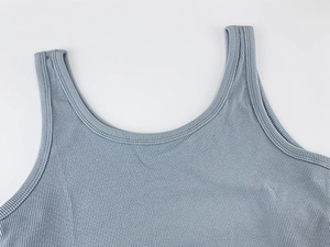 Macro shot of ribbed texture and neckline detail on a slim-fit knitted tank top