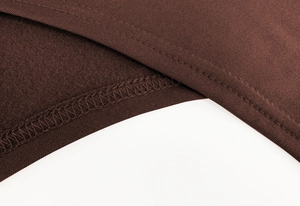 Detailed view of dark brown thermal fabric with fleece lining and premium stitching