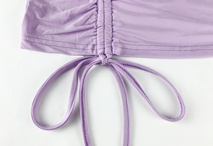 Detail of lavender ruched knit dress with adjustable side drawstring and fine stitching