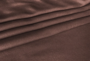 Detailed macro view of chocolate brown ribbed knit fabric with soft vertical texture